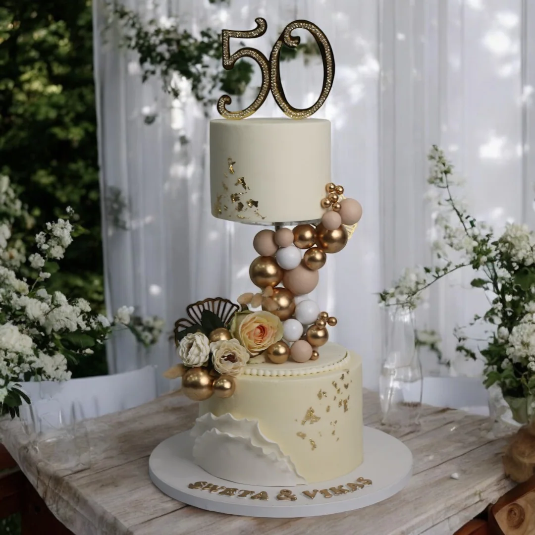 Levitating 50th anniversary cake with gold details and floral accents