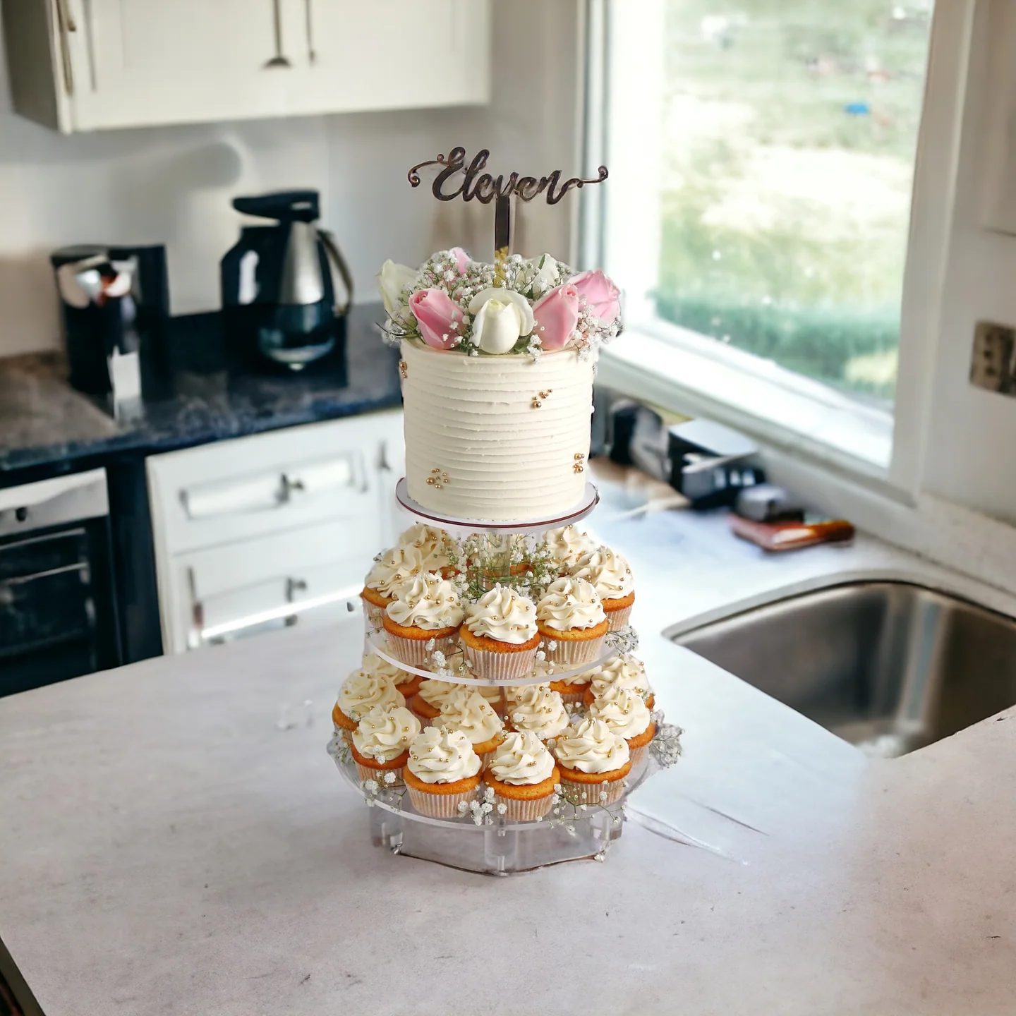 Anniversary cake with floral cupcakes arranged on a tiered stand
