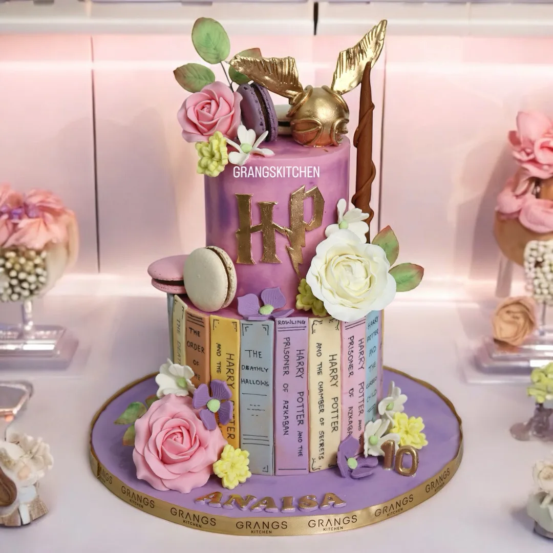 Harry Potter-themed birthday cake with books, flowers and golden details