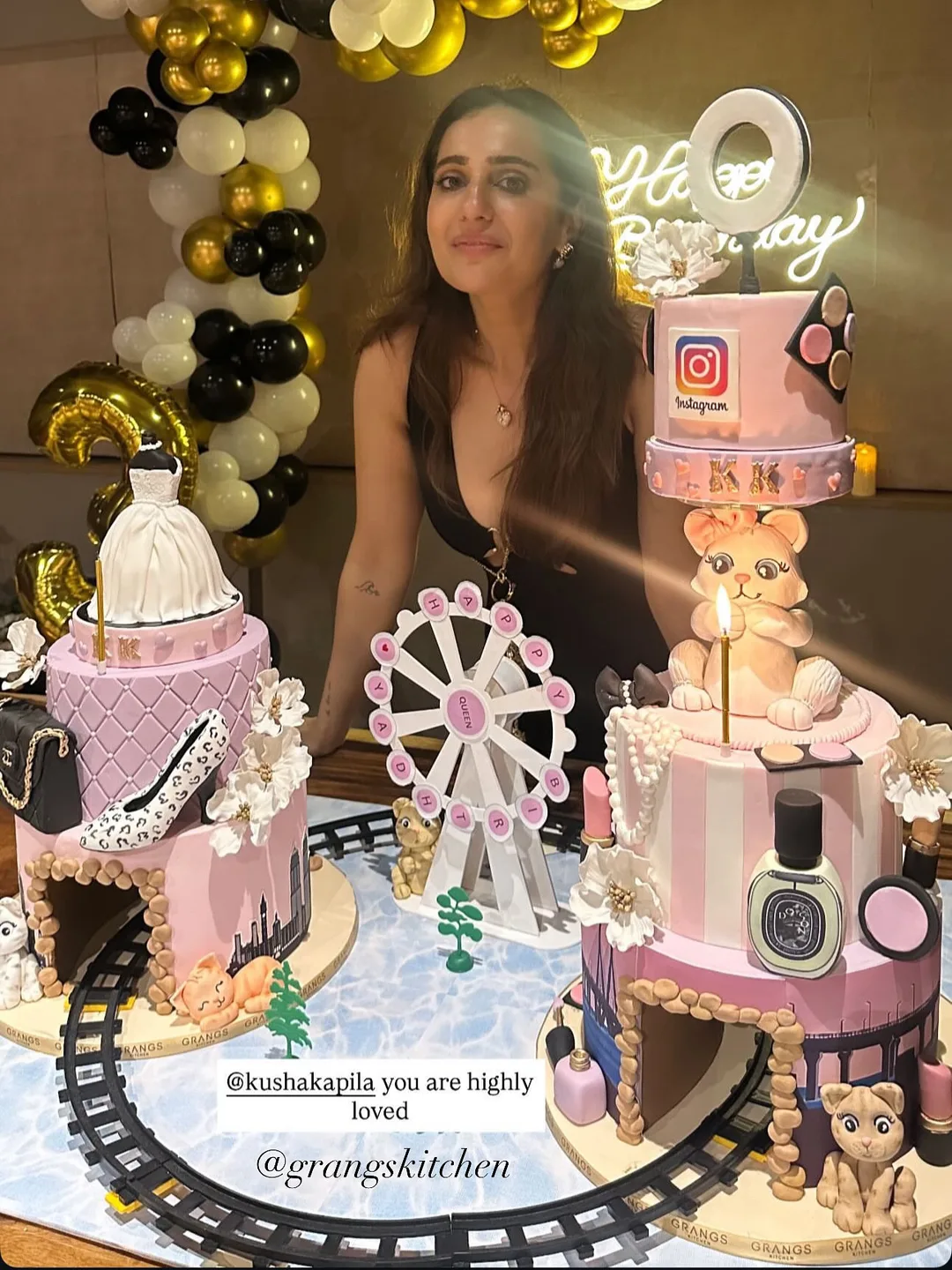 Kusha Kapila beside personalised pink birthday cakes