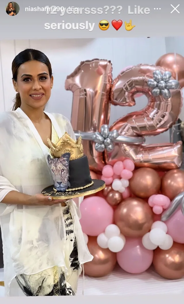 Nia Sharma holding a birthday cake shared from the celebration