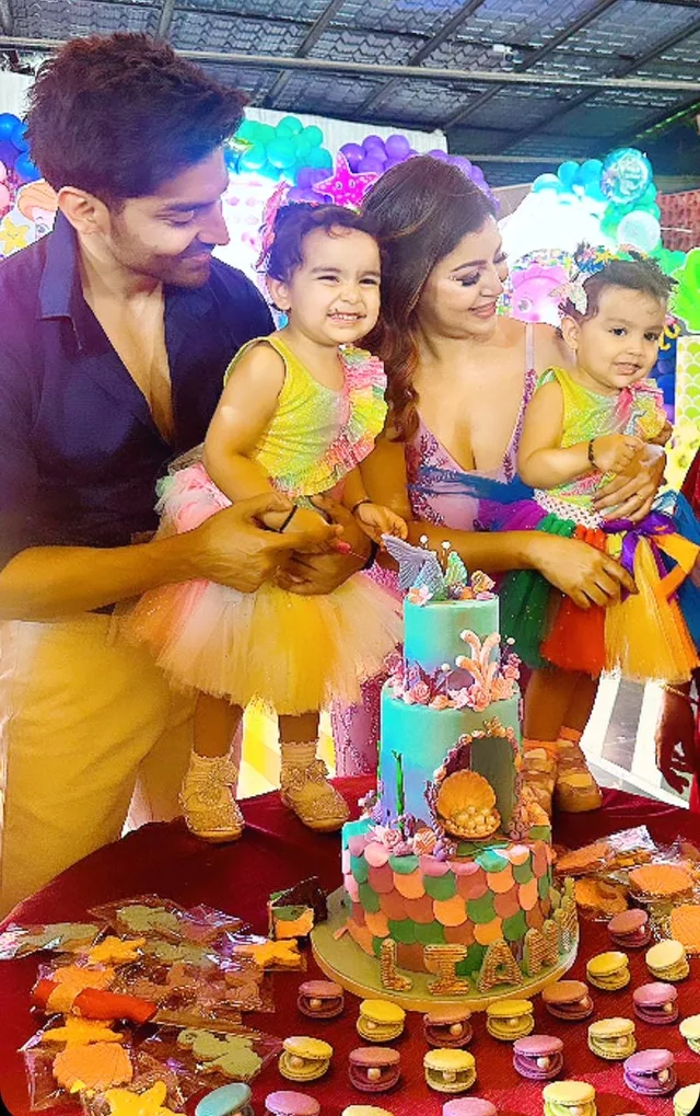 Sunny Leone with family beside a colourful birthday cake