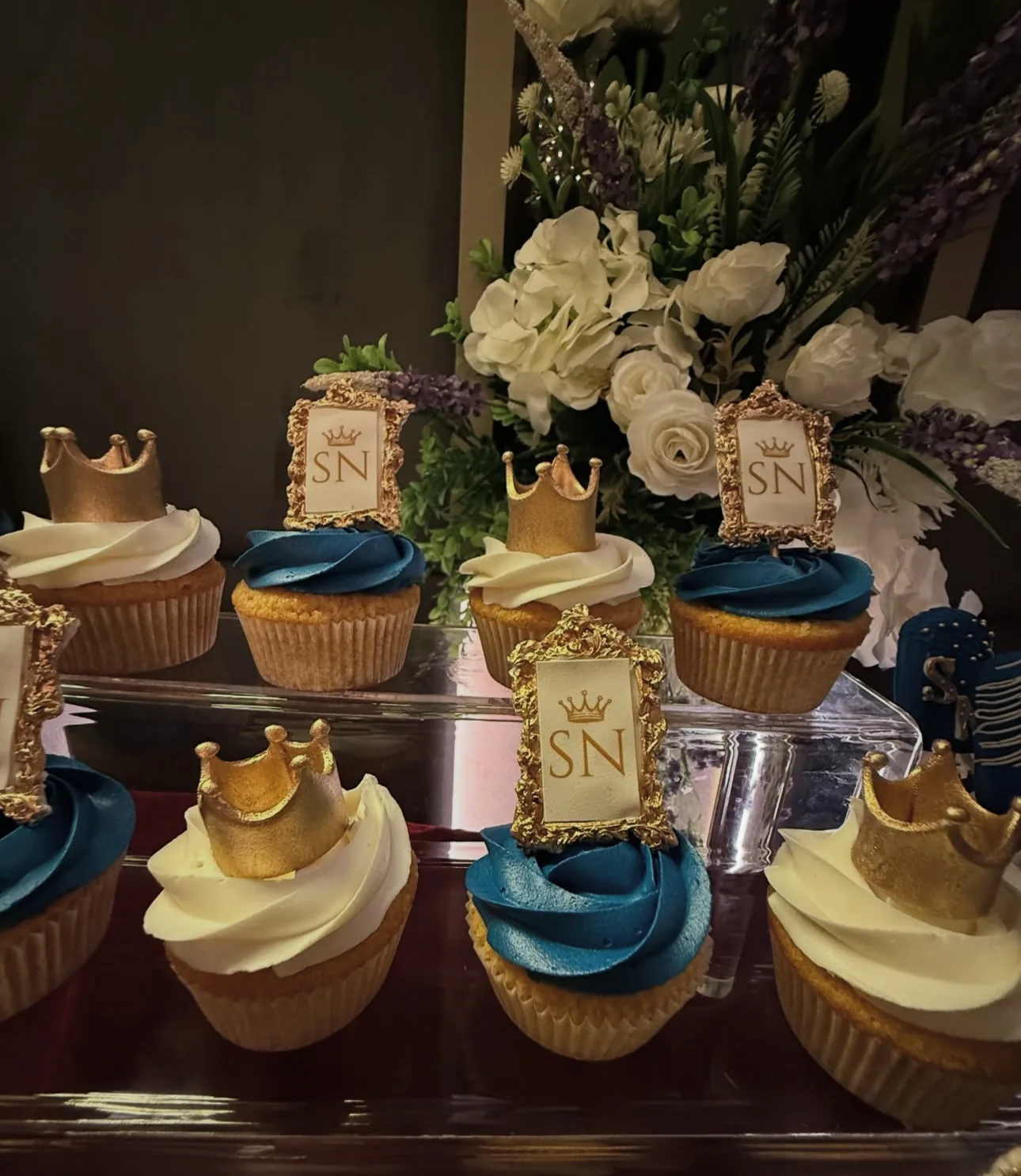 Blue and gold cupcakes arranged for a birthday dessert table