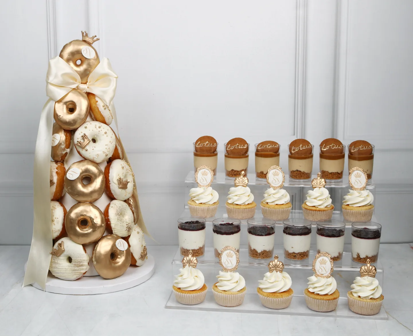 Dessert jars, cupcakes and doughnuts displayed together for a celebration table