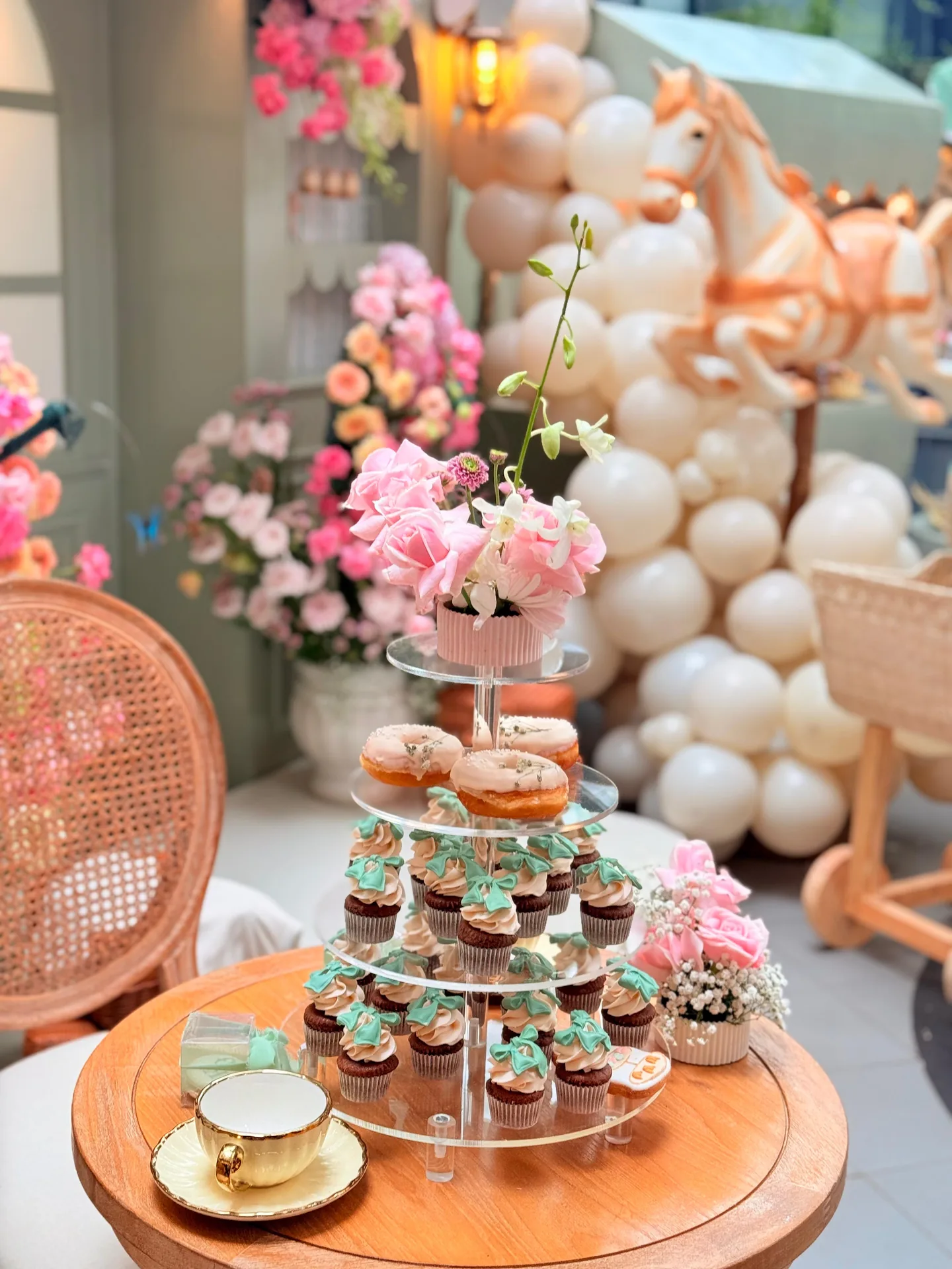 Pastel cupcake stand arranged within a celebration setup
