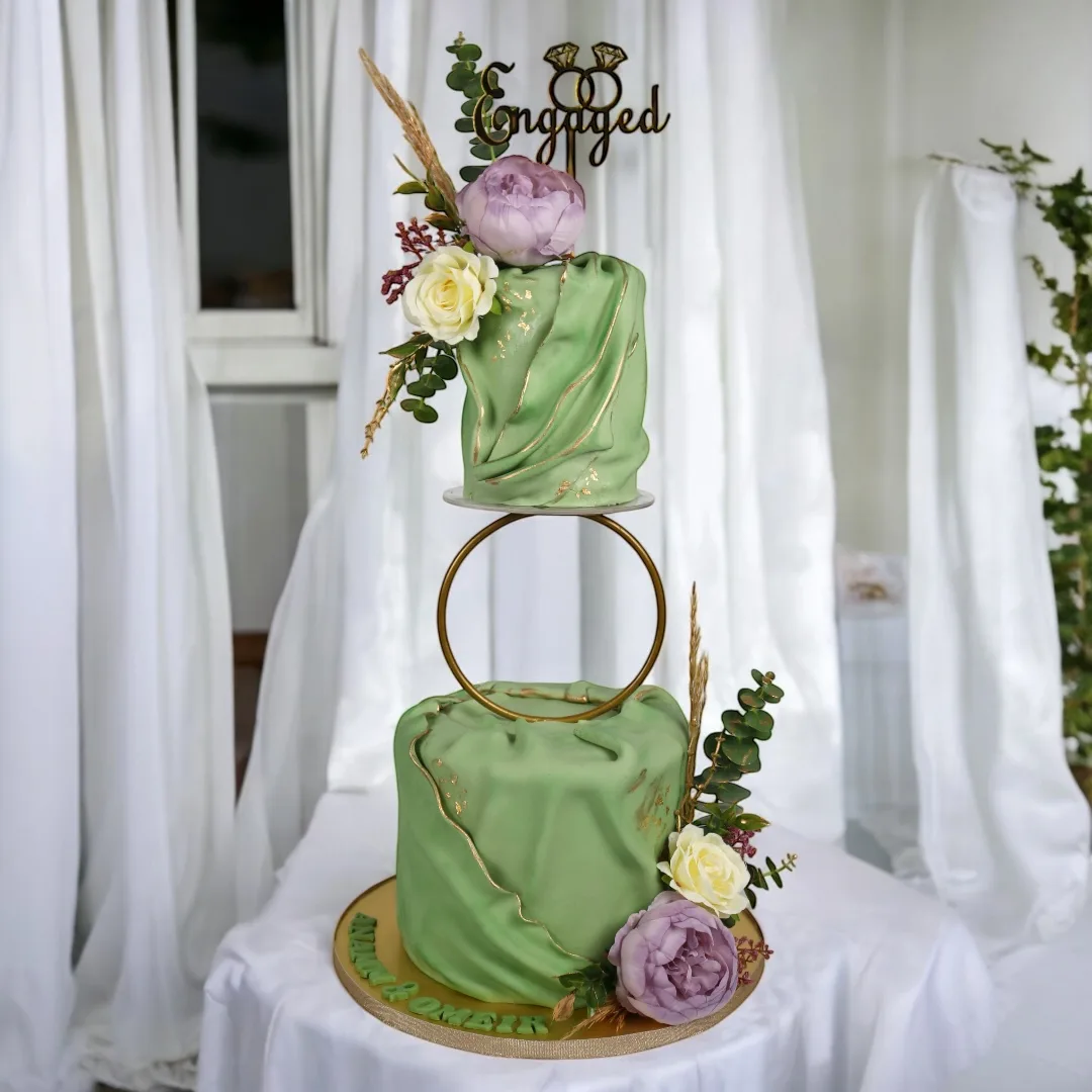 Green levitating engagement cake with florals and gold ring detail