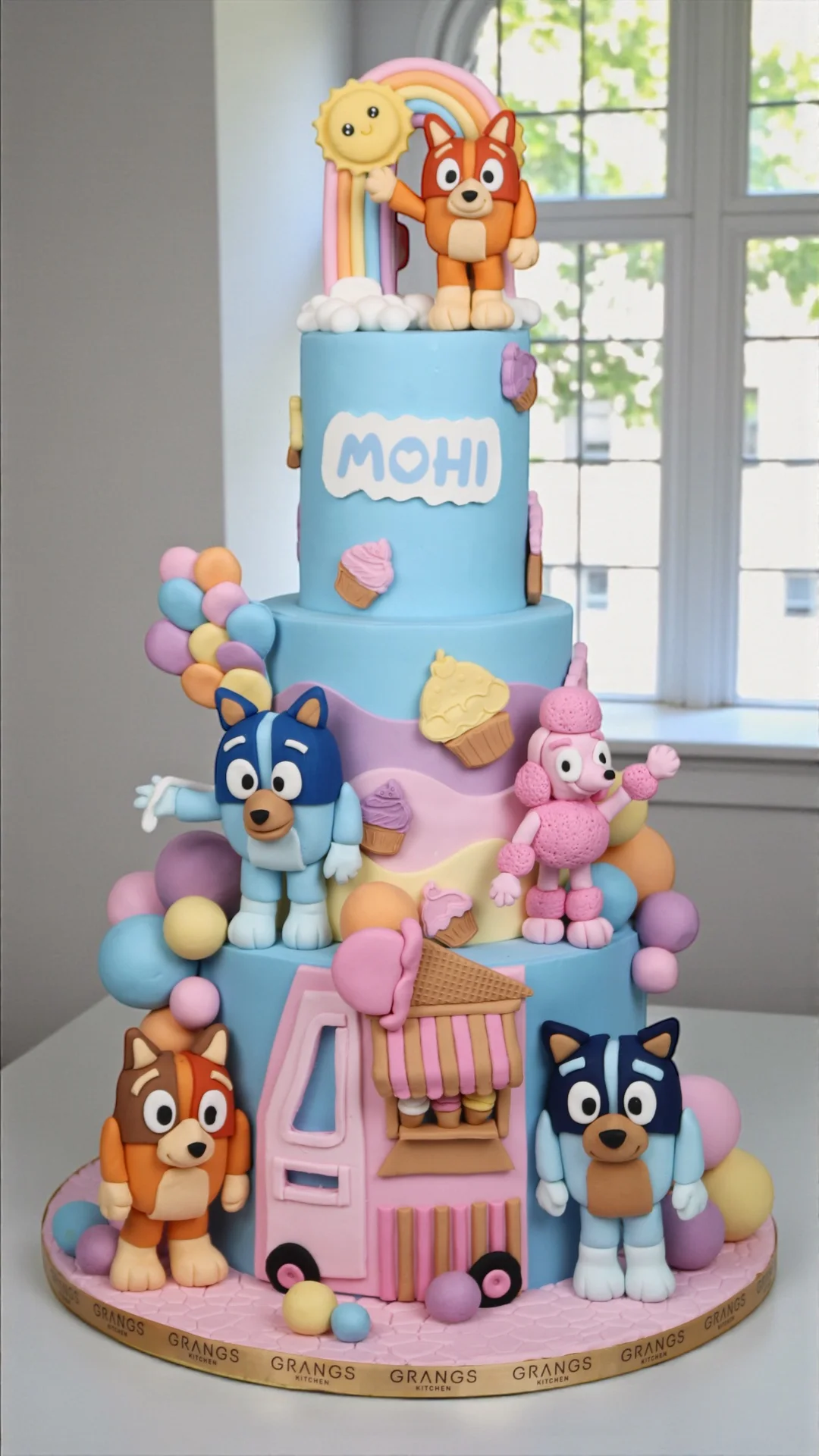 Blue and pink character-themed first birthday cake
