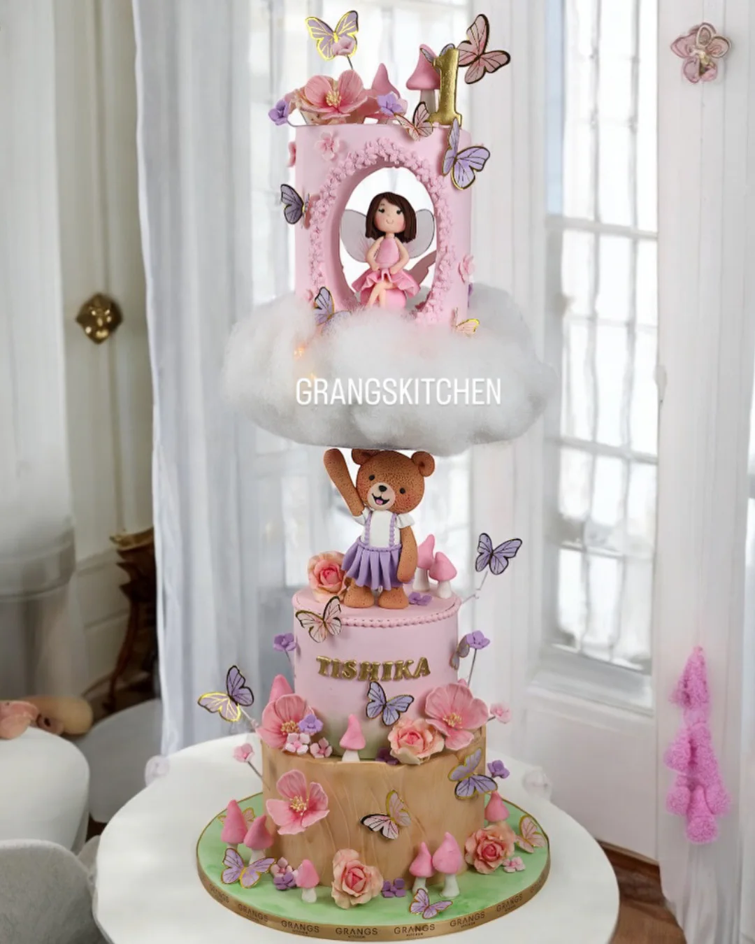 Pink fairy first birthday cake with cloud and butterfly details