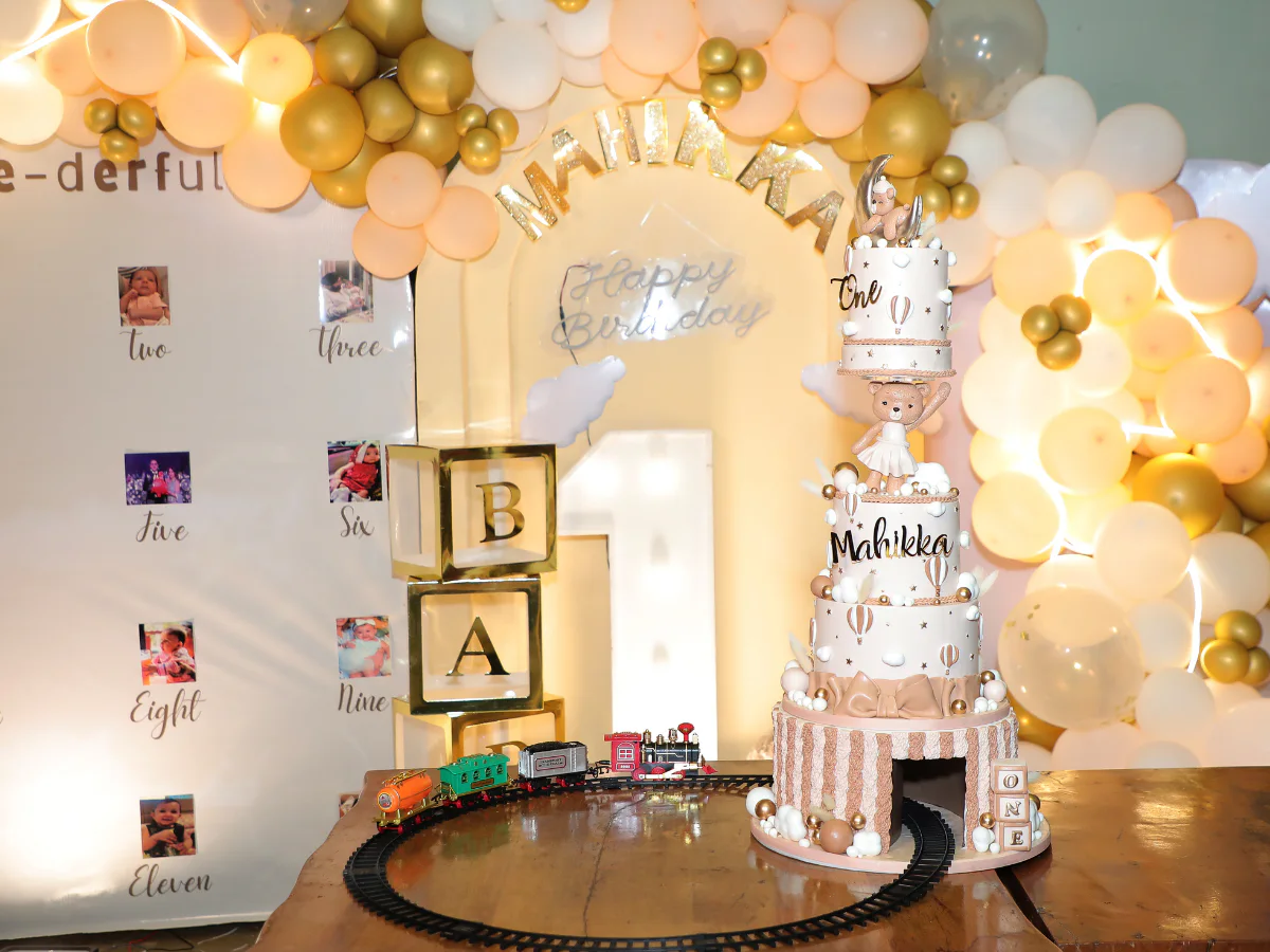 Elaborate train-themed first birthday cake and party setup