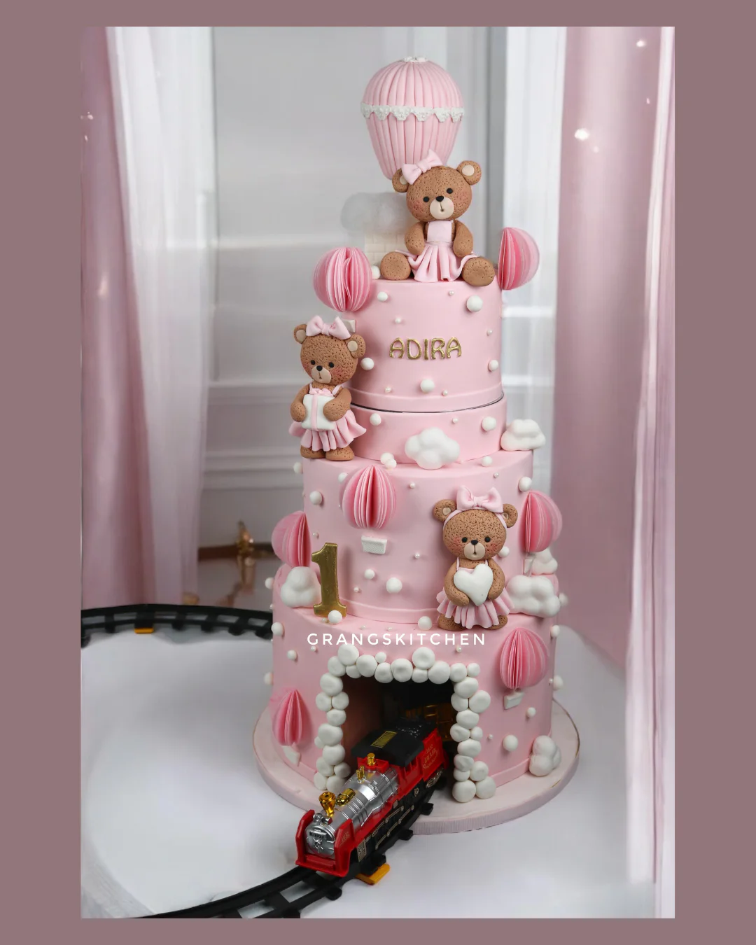 Pink teddy bear and hot-air-balloon first birthday cake