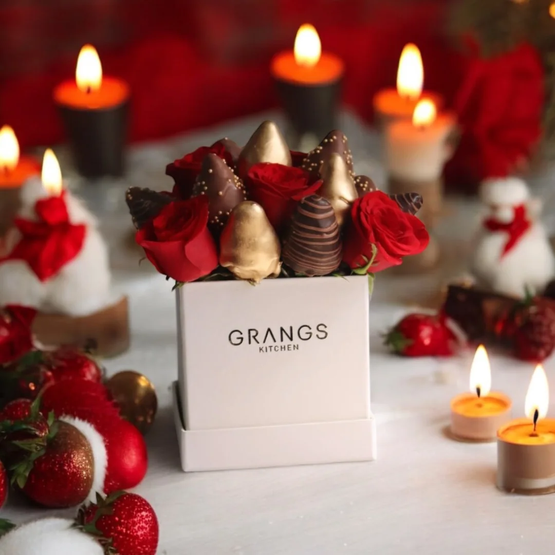 Christmas gift bag with strawberries and boxed treats