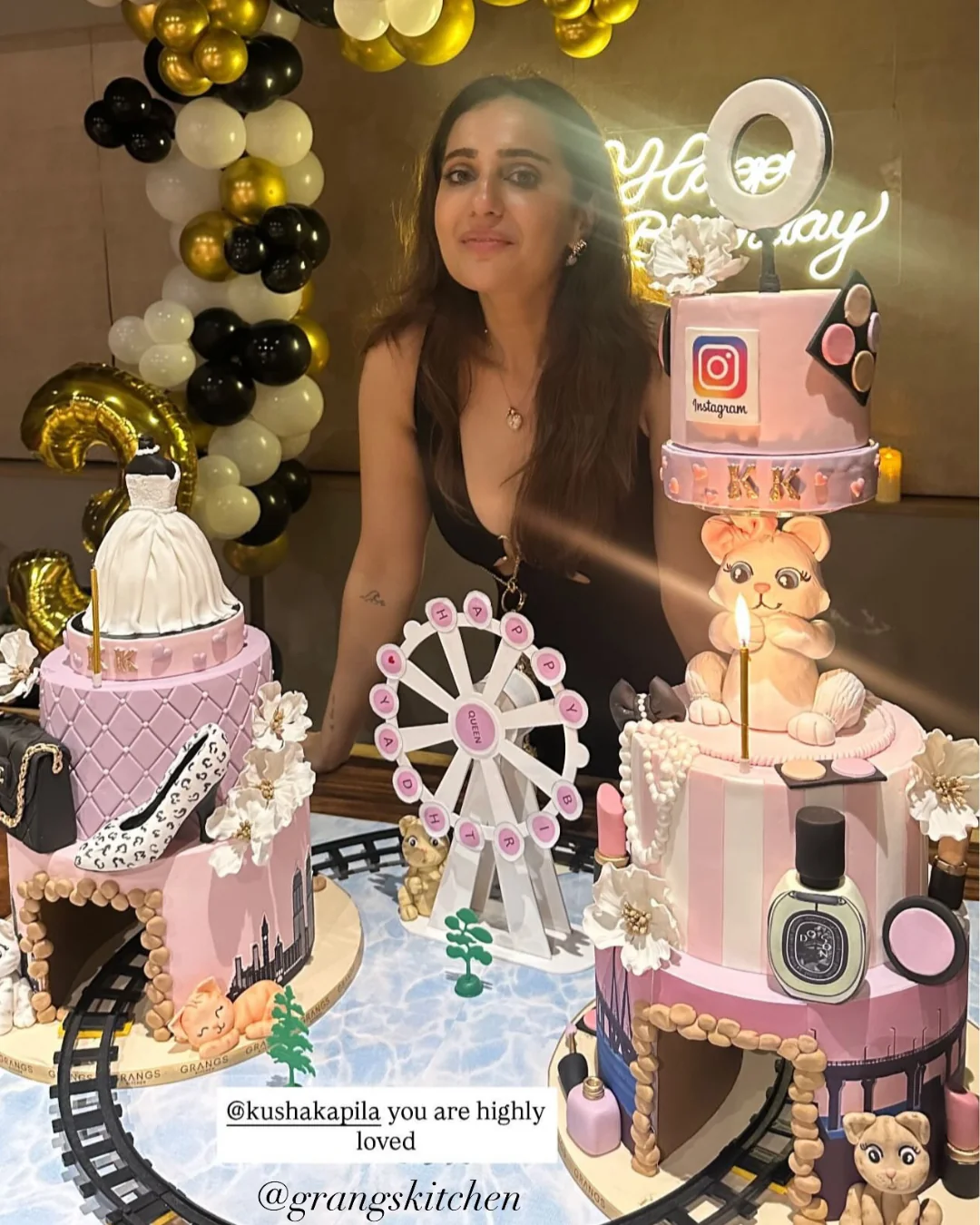 Woman posing beside pink fashion-themed celebration cakes