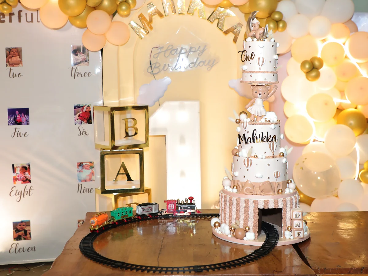 First birthday train cake with balloon backdrop