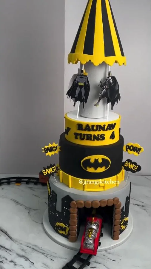 Interactive birthday cake with working toy train moving around the base