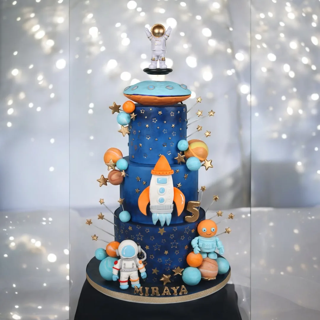 Tall space-themed statement cake with astronaut and rocket details