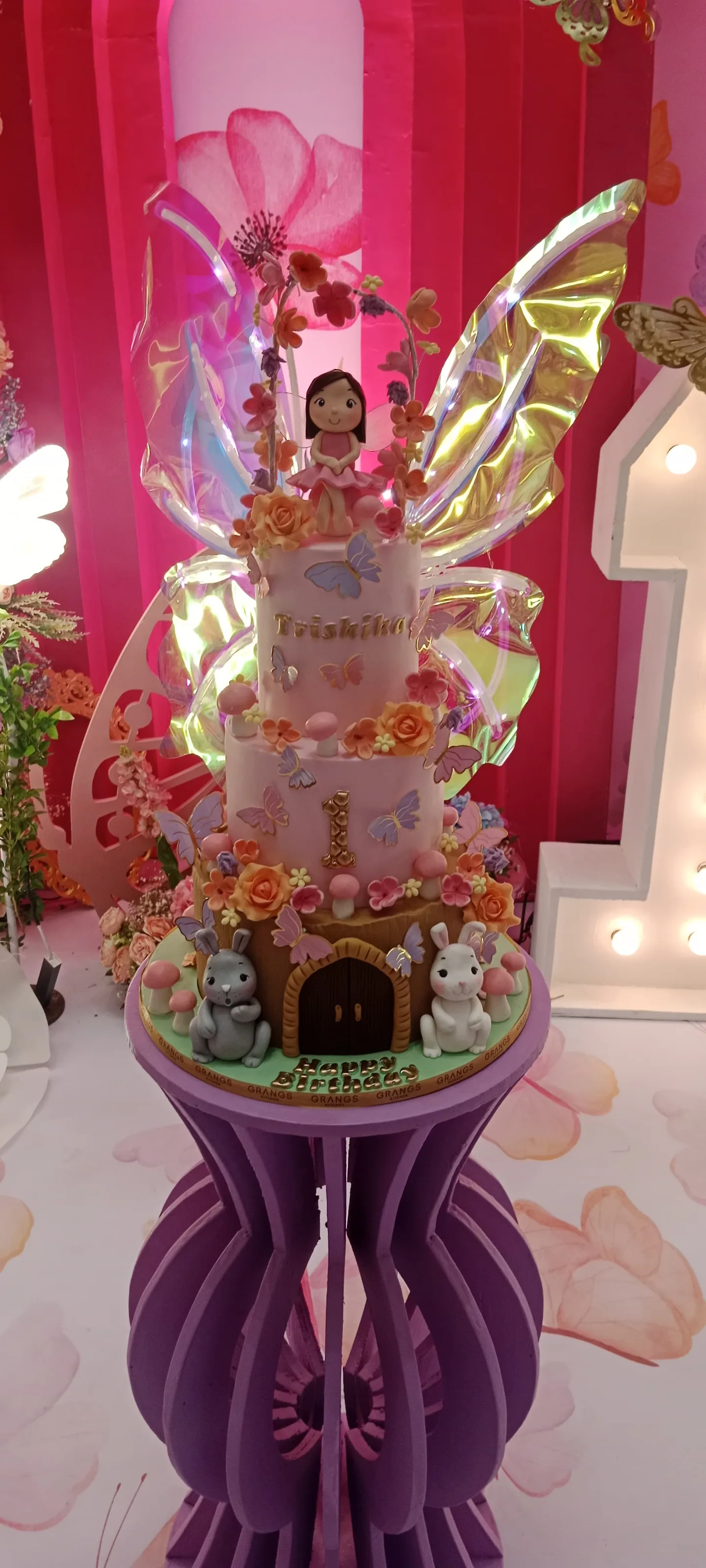 Fairy butterfly cake with glowing wings and garden details