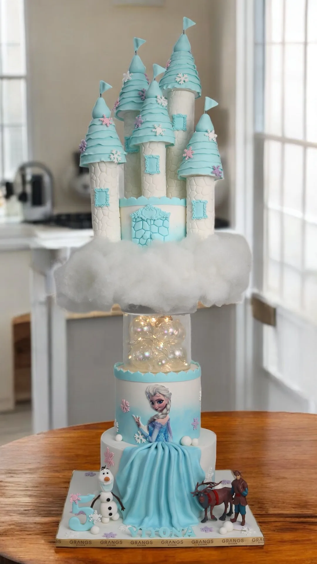Blue princess castle cake with snowflake-inspired details