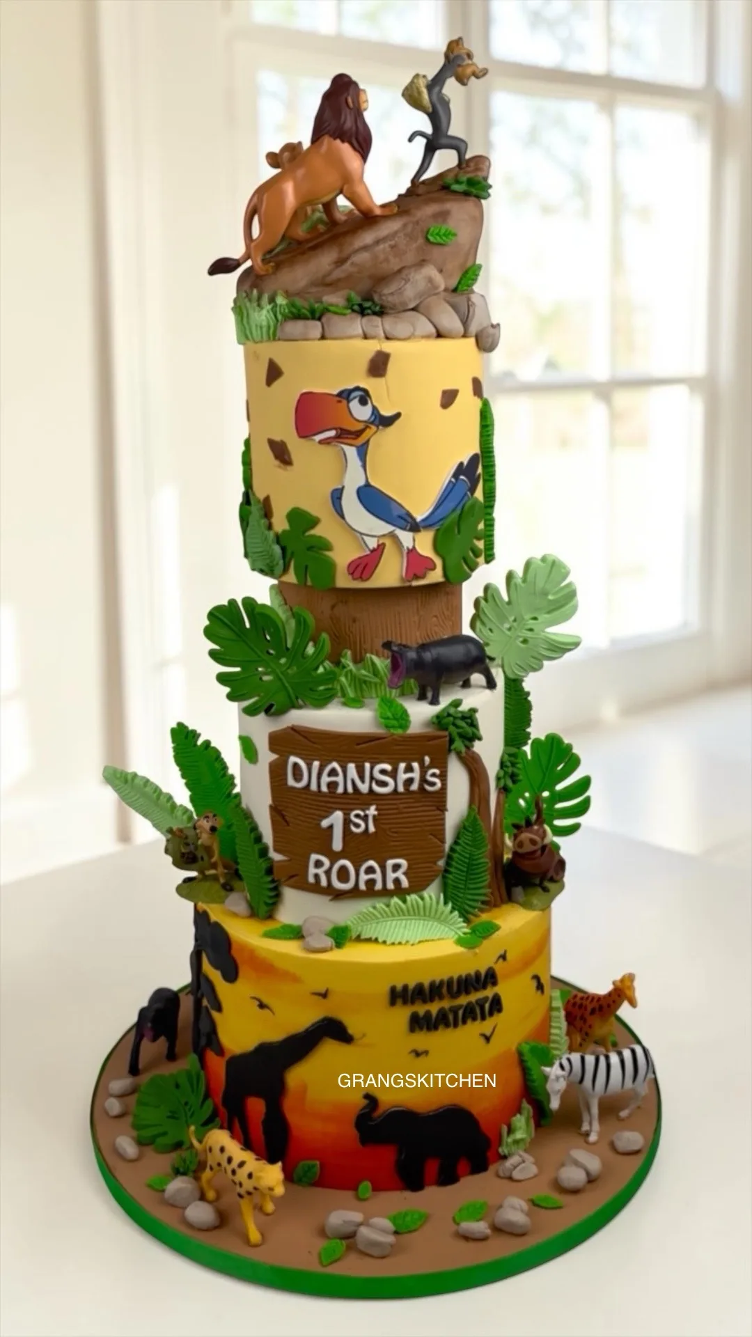 Tall farm and jungle theme cake with animals and green details