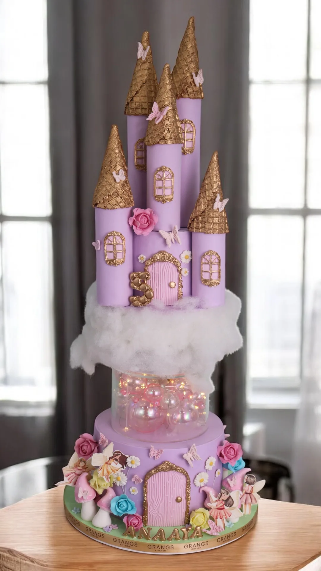 Pink princess castle birthday cake with towers and floral details