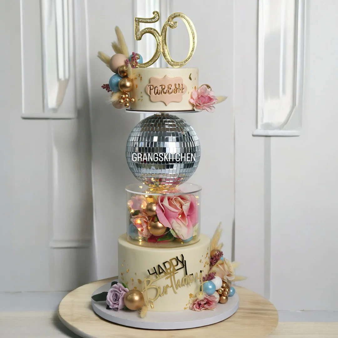 Levitating 50th birthday cake with disco ball, flowers and gold details