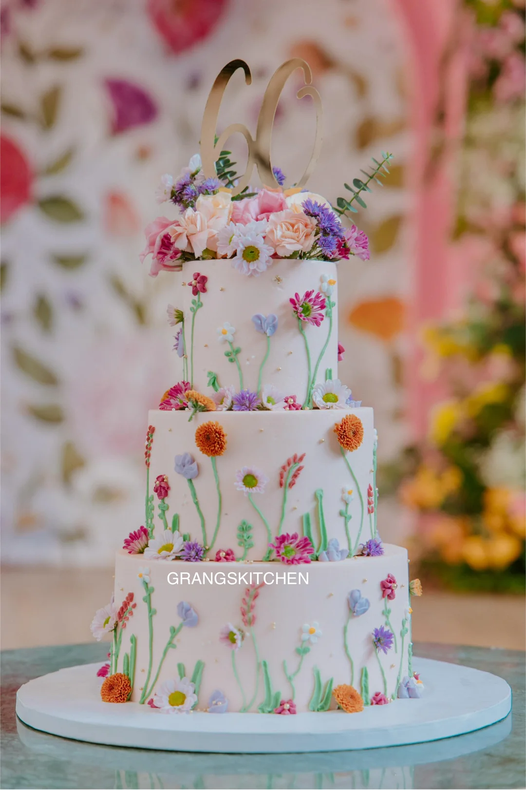 Three-tier floral cake created for a 60th birthday celebration