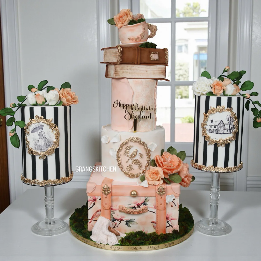 Personalised milestone birthday cake with books, florals and travel-inspired details