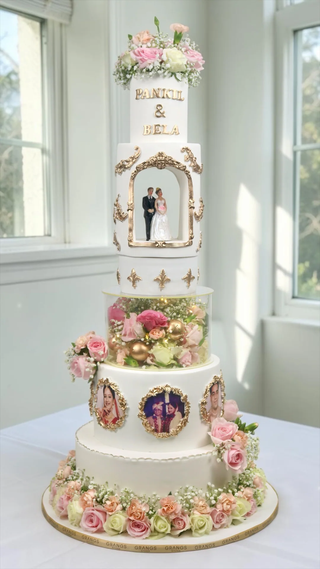 Personalised wedding cake with couple photographs, flowers and gold details
