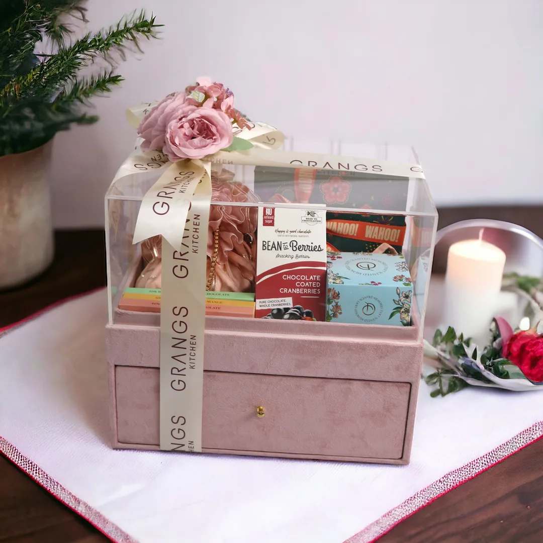 Clear acrylic festive hamper with chocolates and ribboned presentation