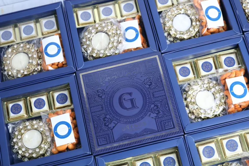 Blue corporate Diwali gift boxes with chocolates, almonds and diyas