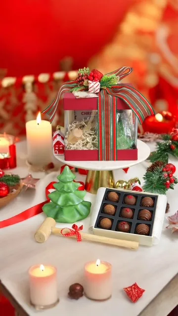 Christmas chocolate hamper with boxed truffles and festive decorations