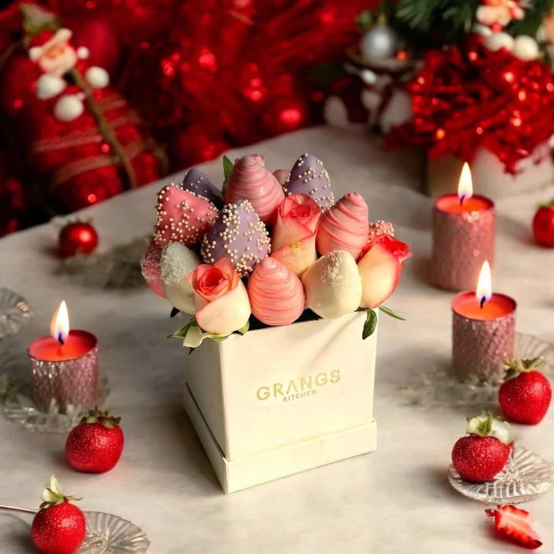 Elegant Christmas gift box with strawberry treats and festive styling